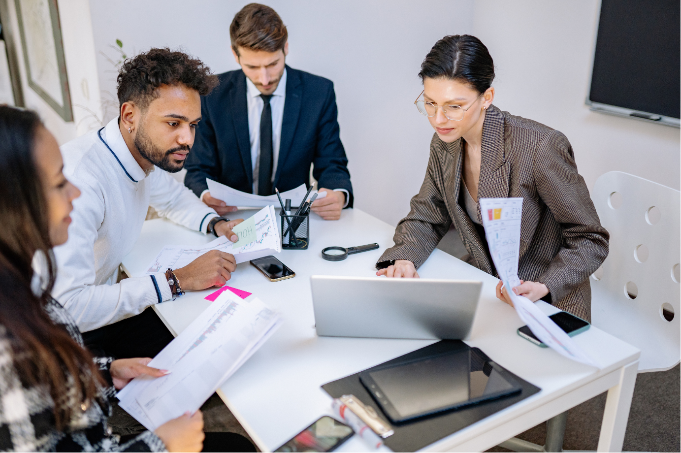 A team of professionals reviewing benefit documents together
